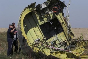 Members of a group of international experts inspect the territory at the site where the downed Malaysia Airlines flight MH17 crashed, near the village of Hrabove