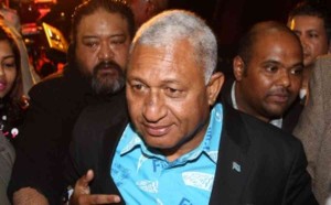 Fiji's interim Prime Minister Frank Bainimarama is surrounded by security and supporters after speaking in Auckland on August 9, 2014. Bainimarama is in New Zealand ahead of election later this year in Fiji.  AFP PHOTO / Michael Bradley        (Photo credit should read MICHAEL BRADLEY/AFP/Getty Images)