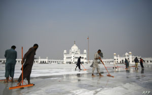 In this picture taken on November 6, 2019 workers clean the floor at the Shrine of Baba Guru Nanak Dev at the Gurdwara Darbar Sahib ahead of its opening in the Pakistani town of Kartarpur near the Indian border. - Thousands of Sikh pilgrims are expected around the world to visit to Pakistan to celebrate the 550th birth anniversary of Sri Guru Nanak Dev which falls on November 12. (Photo by Aamir QURESHI / AFP)